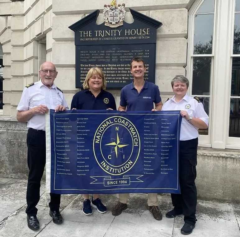 The-anniversary-flag-is-now-at-Trinity-House.-L-R-David-Crozier-NCIs-CEO-Nicola-King-NCI-Filey-Ian-Clarke-Sirius-Insight-Gillian-Woodcock-NCI-Filey.-Credit-Dav