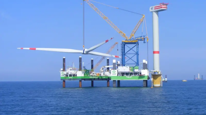 The image shows 'Buzzard' (right) engaged in offshore wind projects