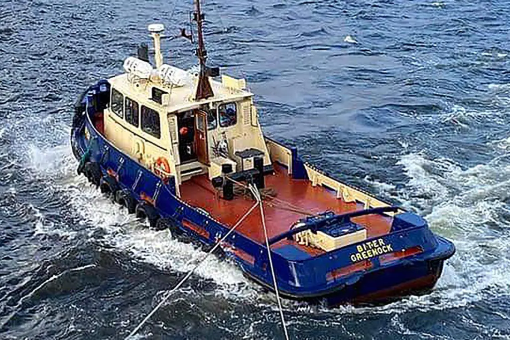 The image shows The Biter, a twin-screw conventional tug at sea before its sinking