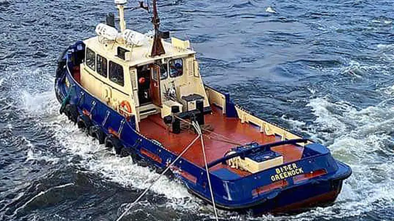The image shows The Biter, a twin-screw conventional tug at sea before its sinking