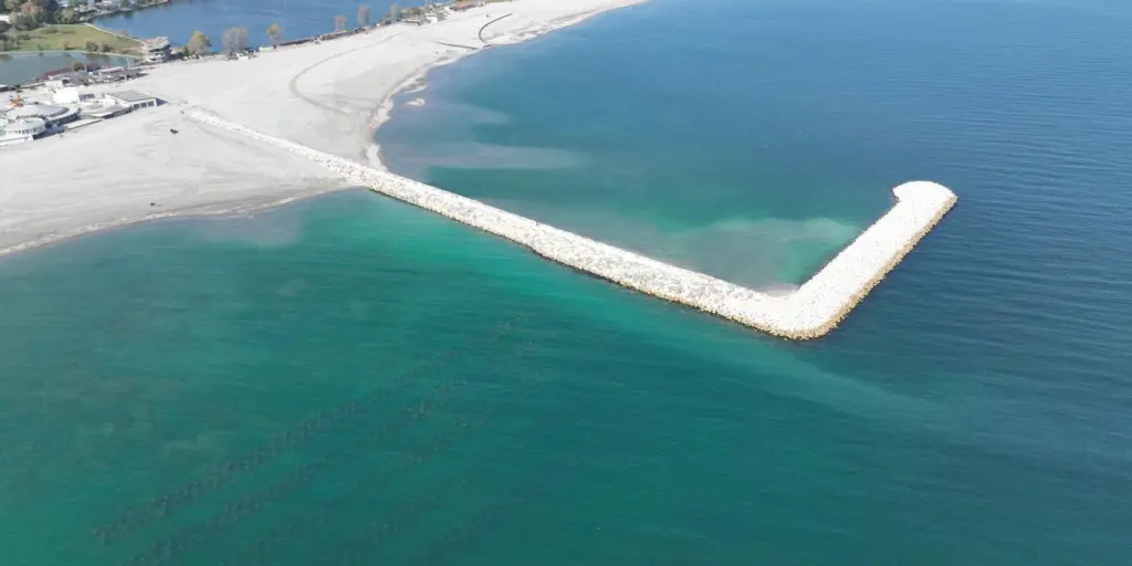 Breakwater jutting out into the sea at Jupiter-Neptun beach in Constanta, Romania