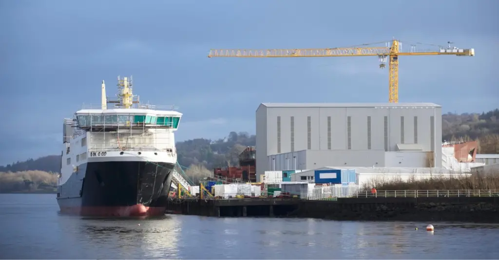 Ship next to warehouse and crane