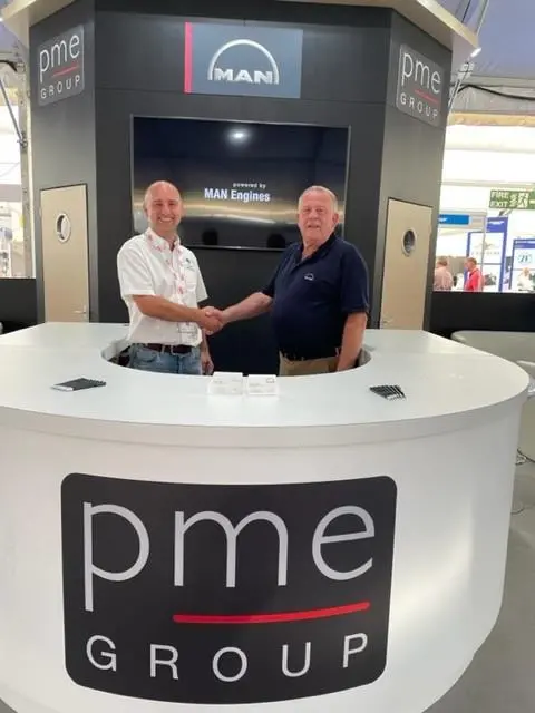 John Warneford, assistant harbourmaster, Port of Milford Haven and Martin Jackson, PME Sales Manager signing a deal at Seawork in 2022