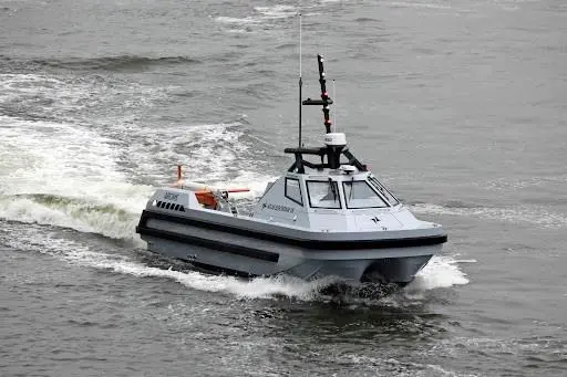 The image shows the ARCIMS unmanned surface vessel (USV) in operational mode