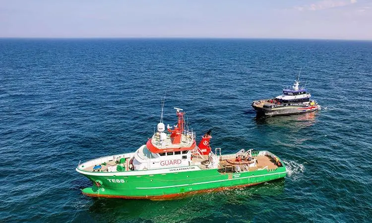 The image shows The image shows the NR Rebellion hybrid Typhoon Class CTV and OEG’s support vessel Tess on the water