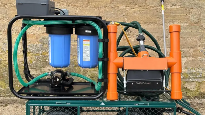 The image shows the Wavecleaner VAC on a trolley