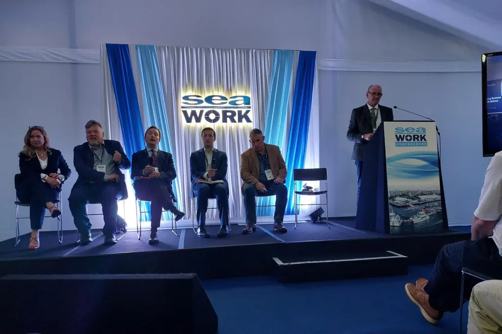 The image shows the speakers from the MOD session taking questions from the audience