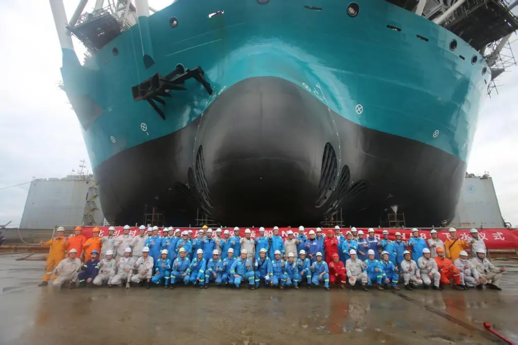 The image shows the build crew in from of the newly launched Norse Energi at the yard