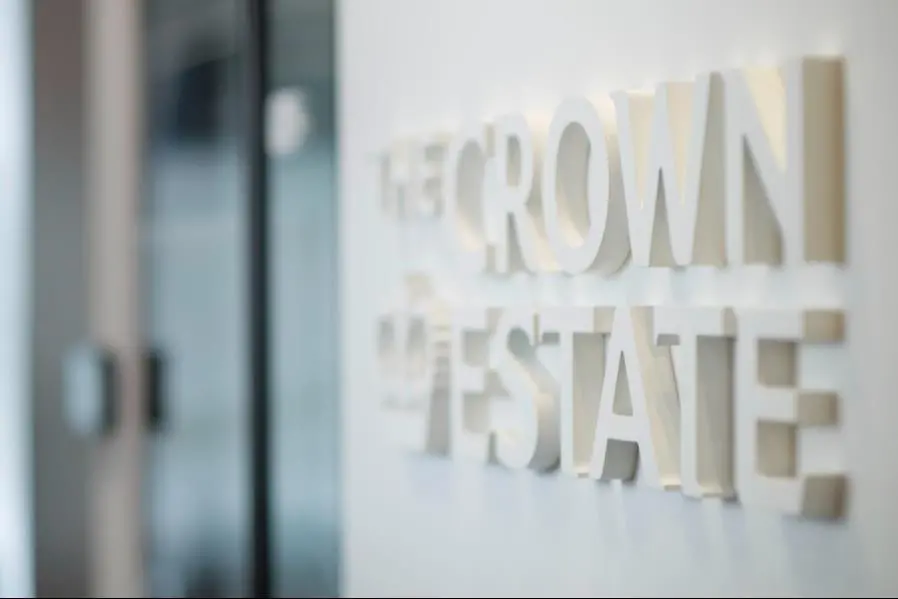 The image shows a wall emblazoned with The Crown Estate