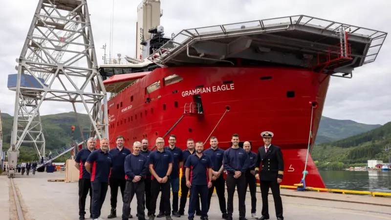 The image shows the newly delivered Grampian Eagle with its crew at the quayside