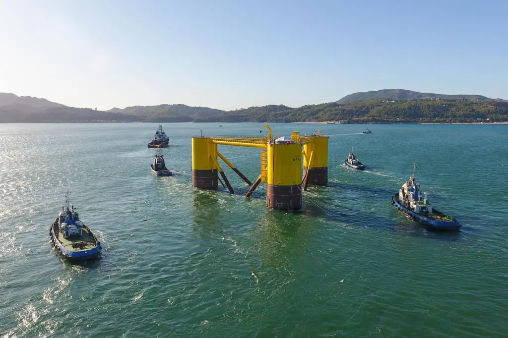 The image shows WindFloat leaving Lisnave dock after construction near Setúbal, Portugal