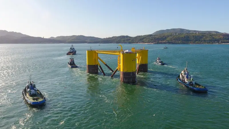The image shows WindFloat leaving Lisnave dock after construction near Setúbal, Portugal
