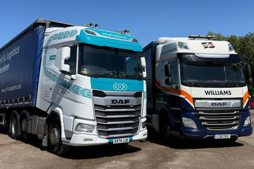 The image shows a Williams Shipping and GIF Transport truck side by side