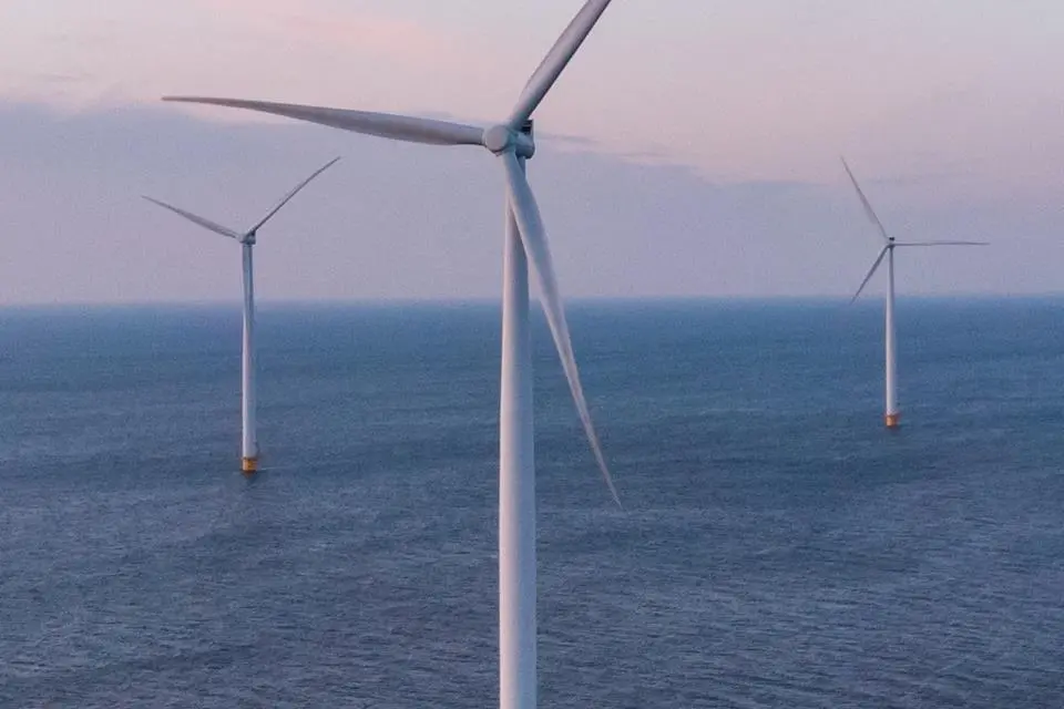 The image shows offshore wind turbines