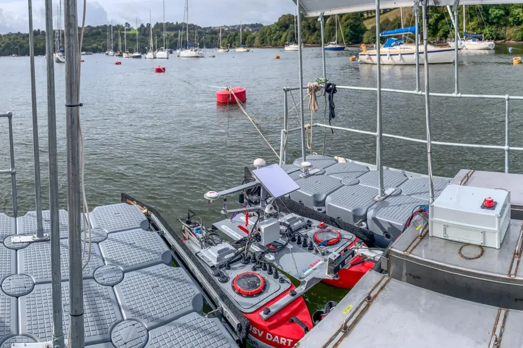 The image shows a USV docked at a centralised hub during the project