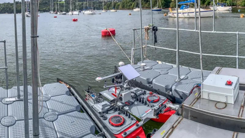 The image shows a USV docked at a centralised hub during the project