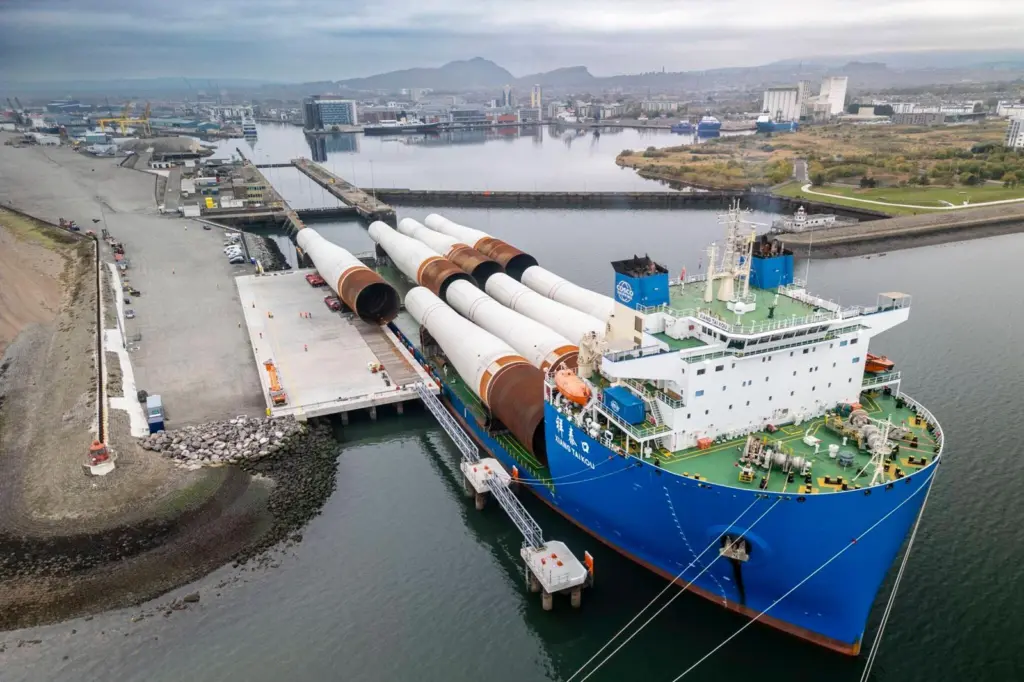 The picture shows the eight massive monopiles arriving via heavy transport vessel at the new deep-water Charles Hammond Berth