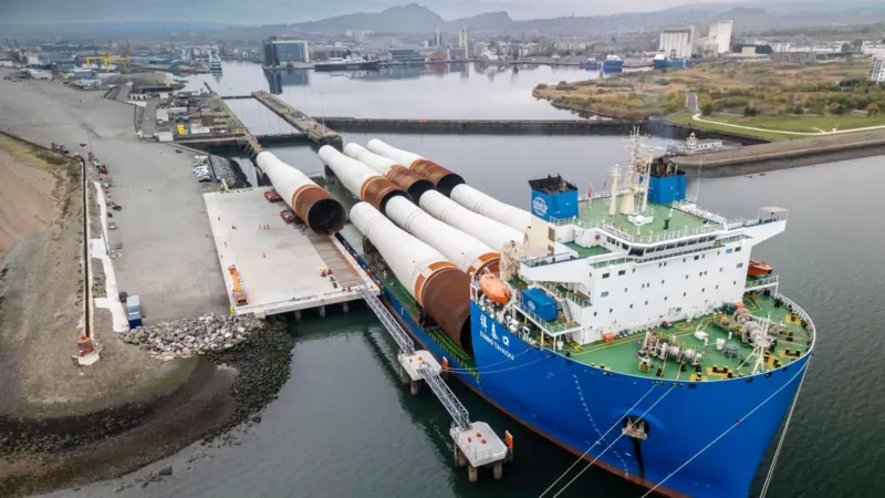 The picture shows the eight massive monopiles arriving via heavy transport vessel at the new deep-water Charles Hammond Berth