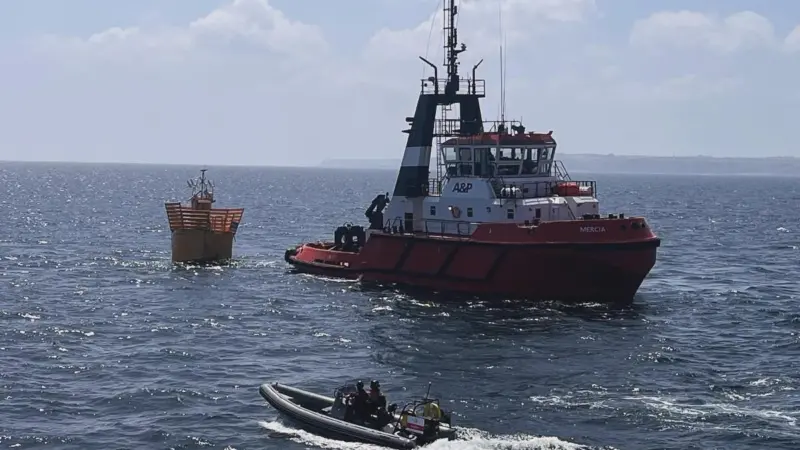The image shows a MMS workboat on the water