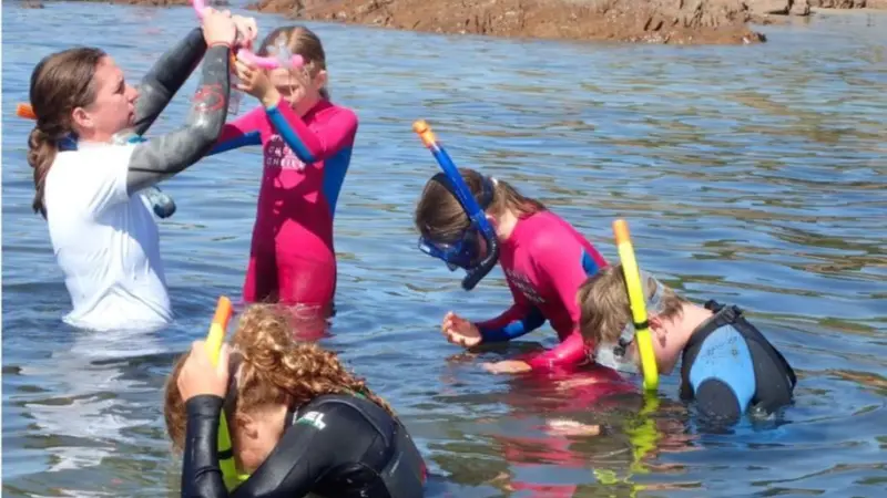 A picture of young marine enthusiasts learning to snorkel