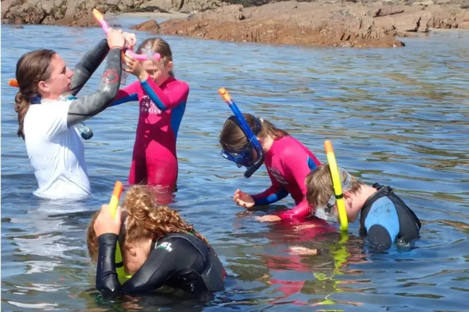 A picture of young marine enthusiasts learning to snorkel