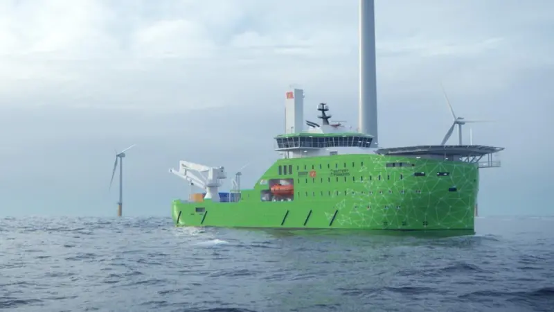 A Bibby Marine offshore service vessel on the water with wind turbines in the background