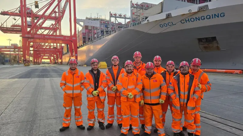 A picture of a group of PPG Apprentices dressed in orange uniforms on the quayside