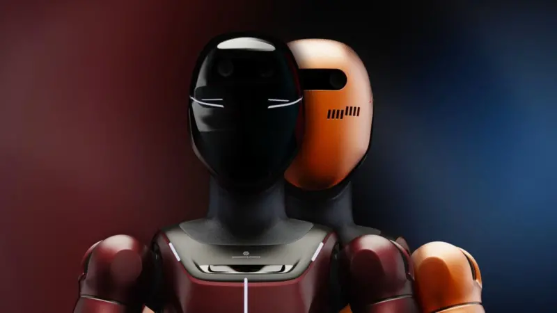 image of two robots, one with a welding mask