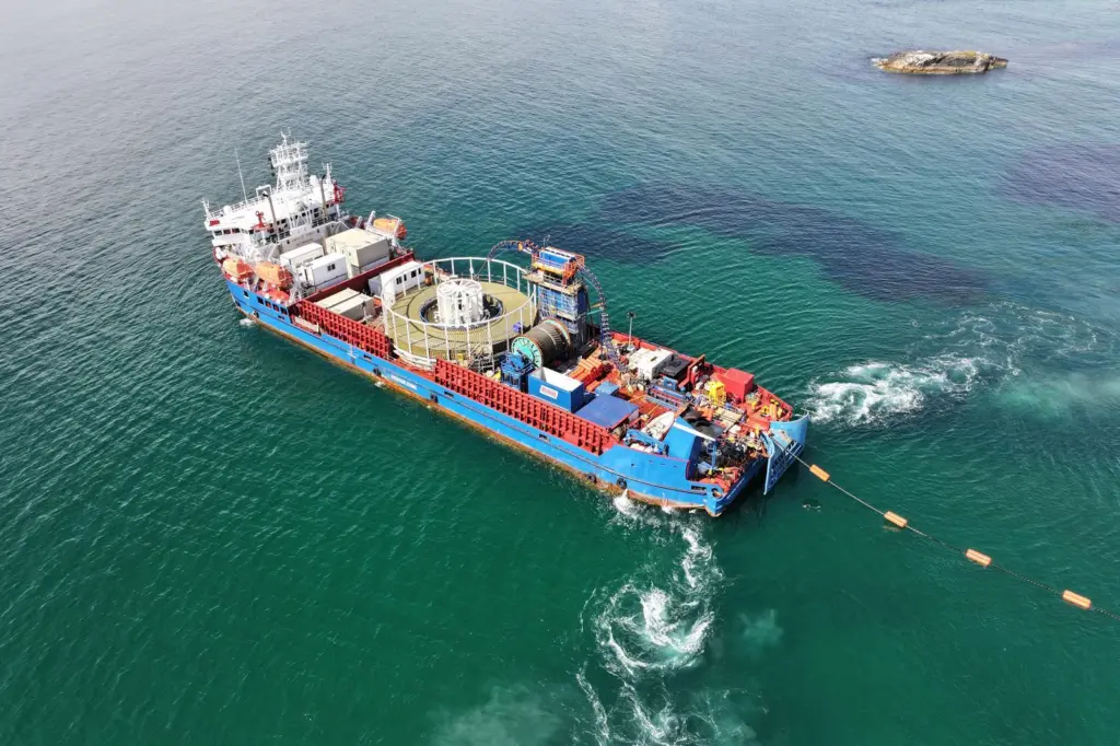 The image shows a Briggs Marine Cable Lay Vessel in action