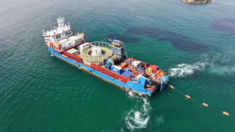 The image shows a Briggs Marine Cable Lay Vessel in action