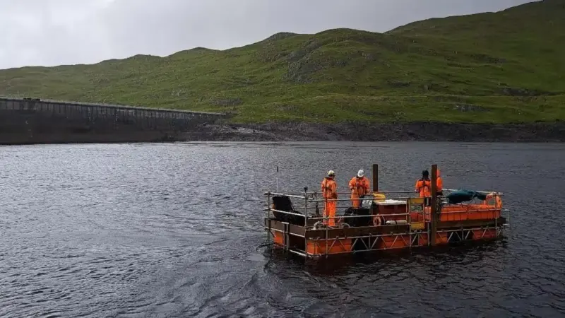 ScaffFloat floating work platform surveying onsite next to the operational dam