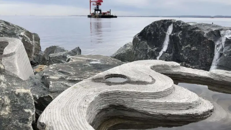 The image shows tide pools integrated into the rock breakwaters