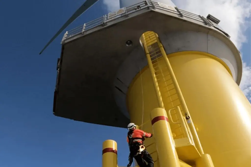 A worker scaling the side of a wind turbine from Seatrium