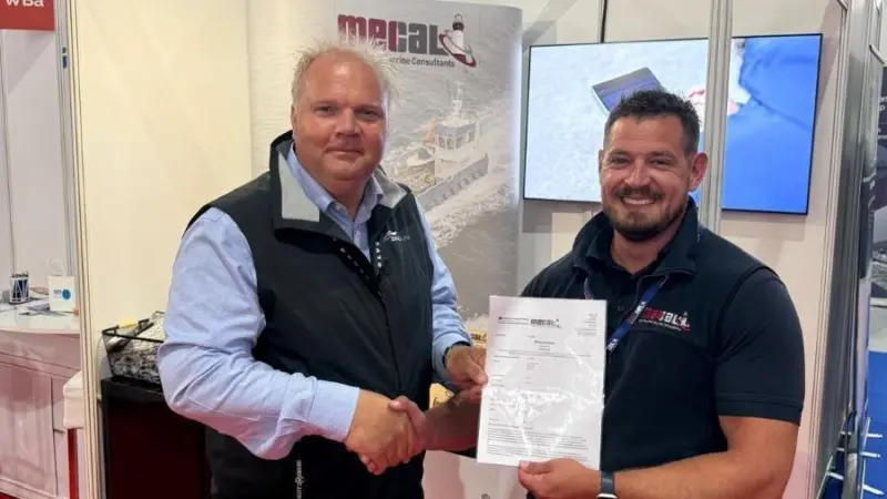 Zero USV Matthew Ratsey receives the certificate from Owen Preece, from MECAL