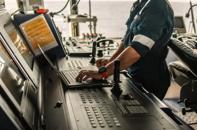 Marine Navigation Officer using laptop